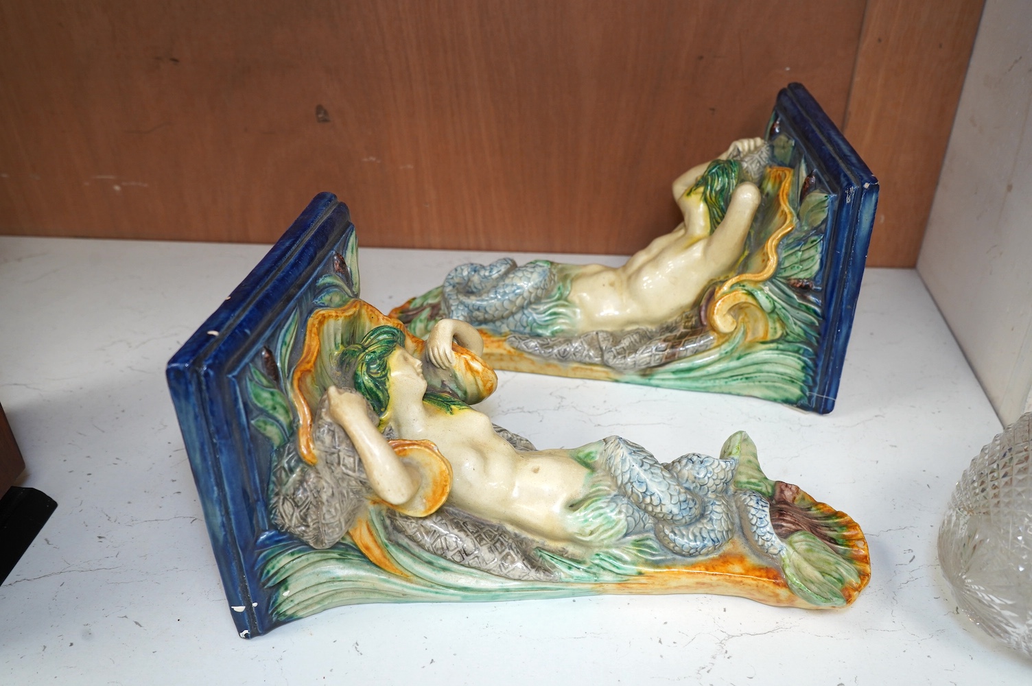 A pair of late 19th century Continental majolica ‘mer people’ wall brackets, 30cm. Condition - fair to good